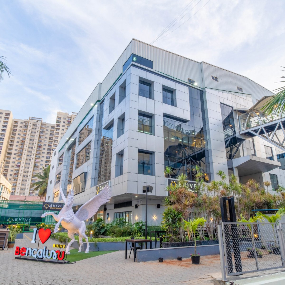 BHIVE campus building exterior with the I Love Bengaluru Pegasus statue