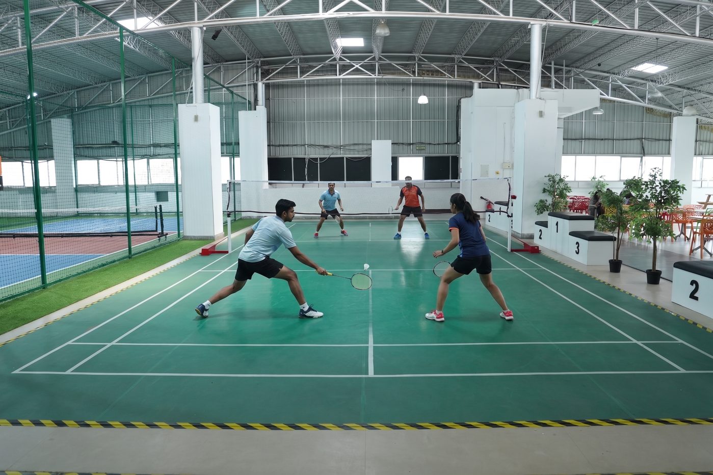 Indoor badminton court at a BHIVE Sports Zone
